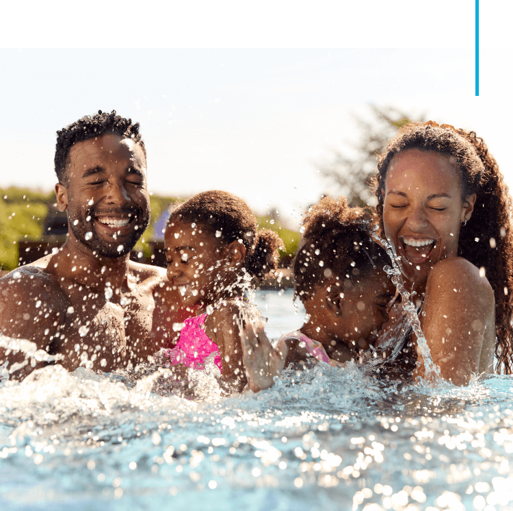 A family playing in the water at the beach.